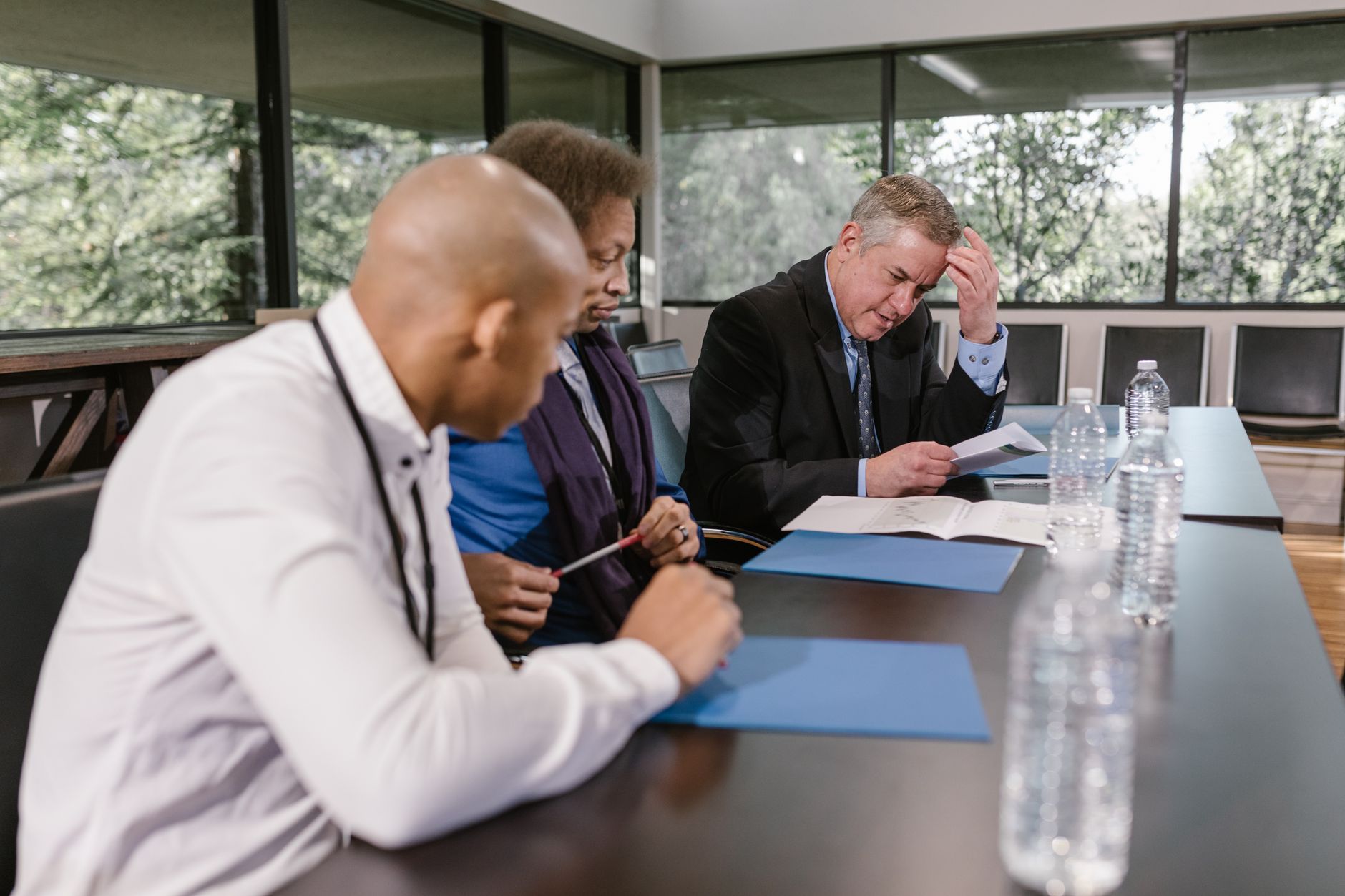 Colleagues in a meeting reviewing printed documents